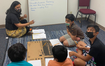 A Vedic maths lesson with students working through Ekadhikena Purvena