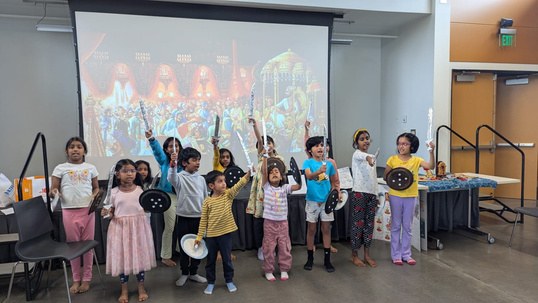 Aum School students performing on stage during a summer celebration