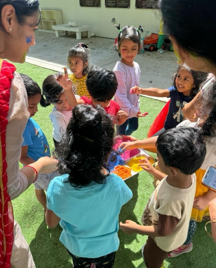 Children celebrating Holi with colours in the play yard