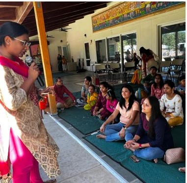 A community dharma talk with parents seated together