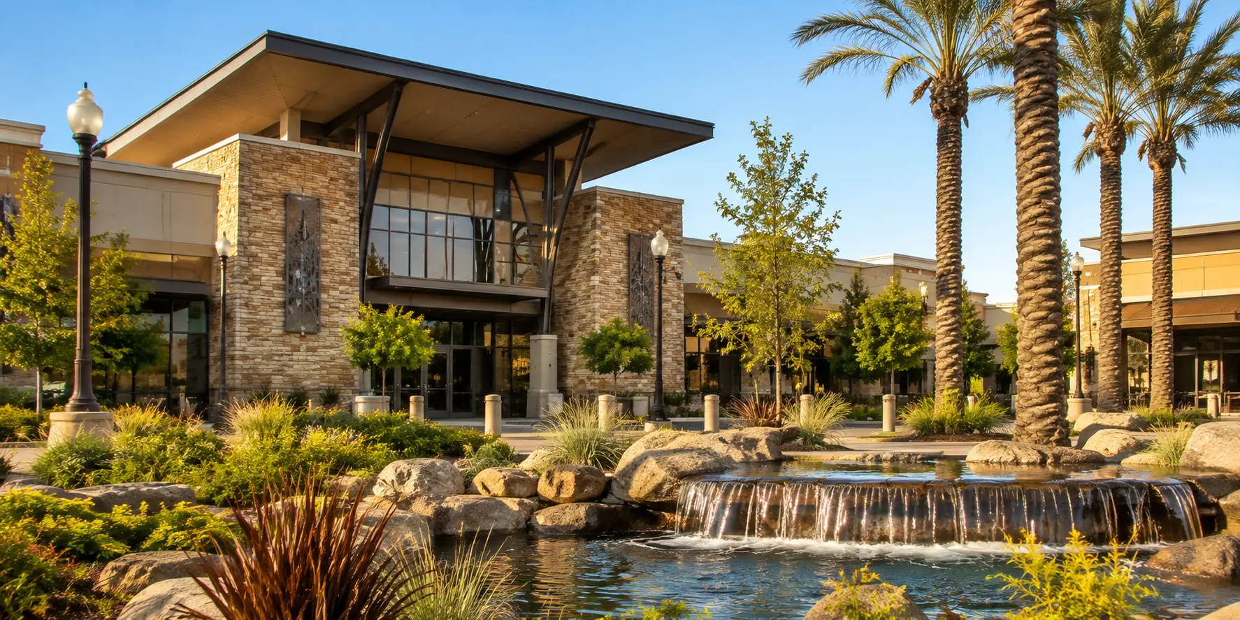 Sunlit town center with palm trees and a fountain in Lathrop, California