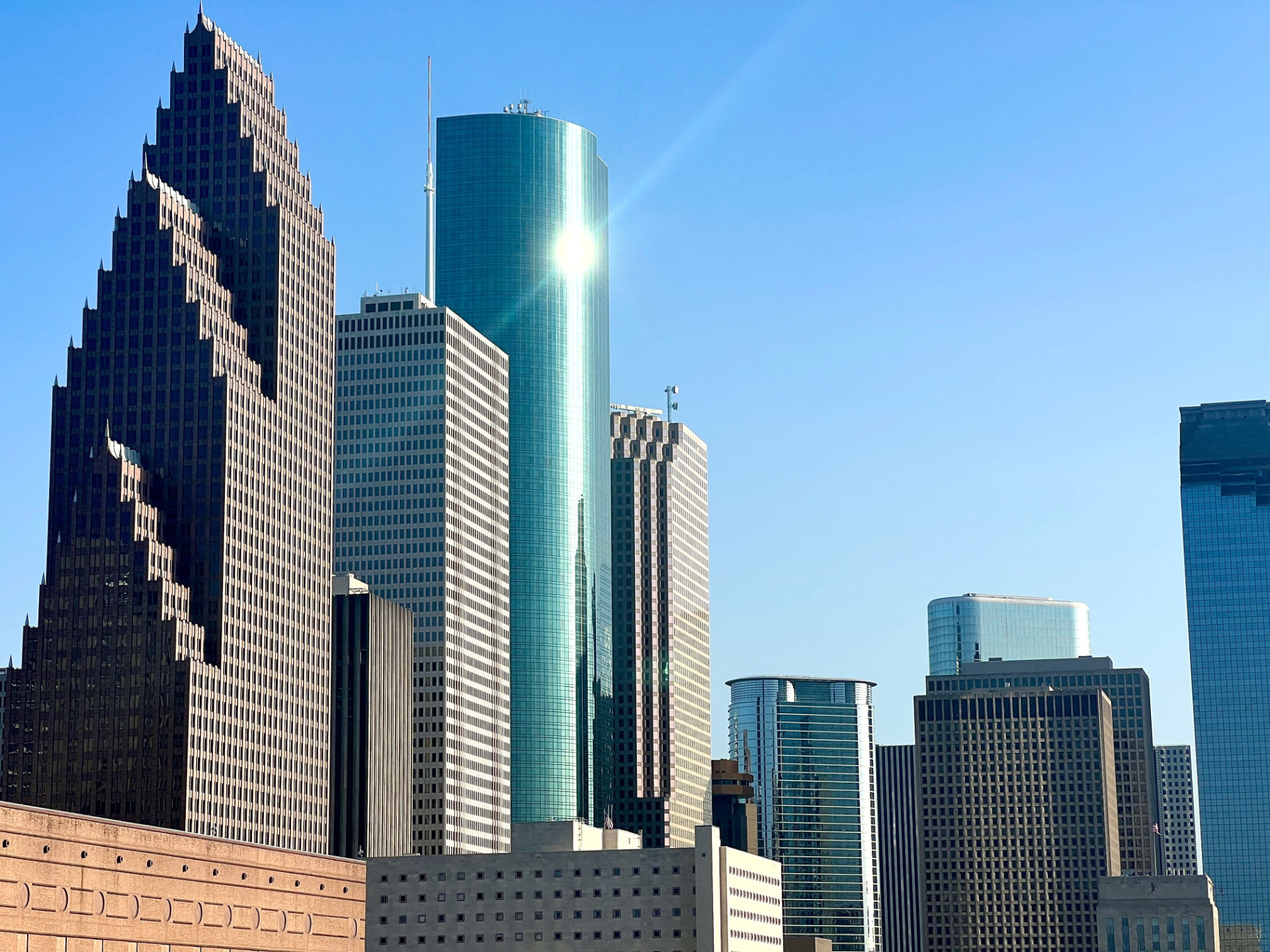 Downtown Houston skyline on a sunny day near the Aum School Houston campus