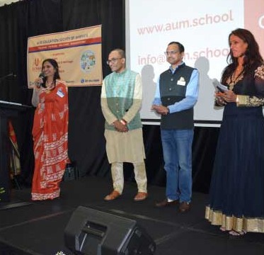 Aum Education Society of America members presenting at a community gathering