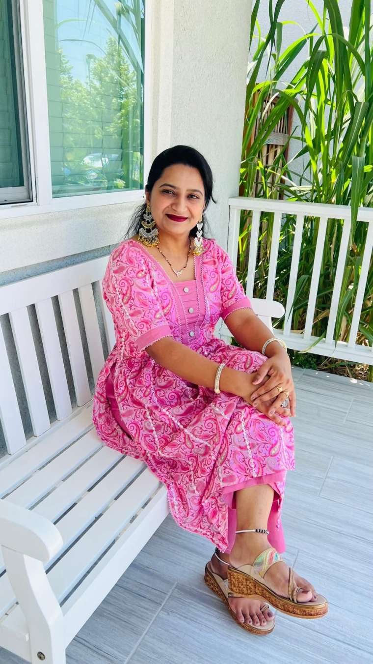 Ms. Poonam, Lead Preschool Teacher at Aum Little Learners Lathrop, seated on a garden bench