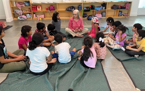 Students gathered in a circle for a guided story session
